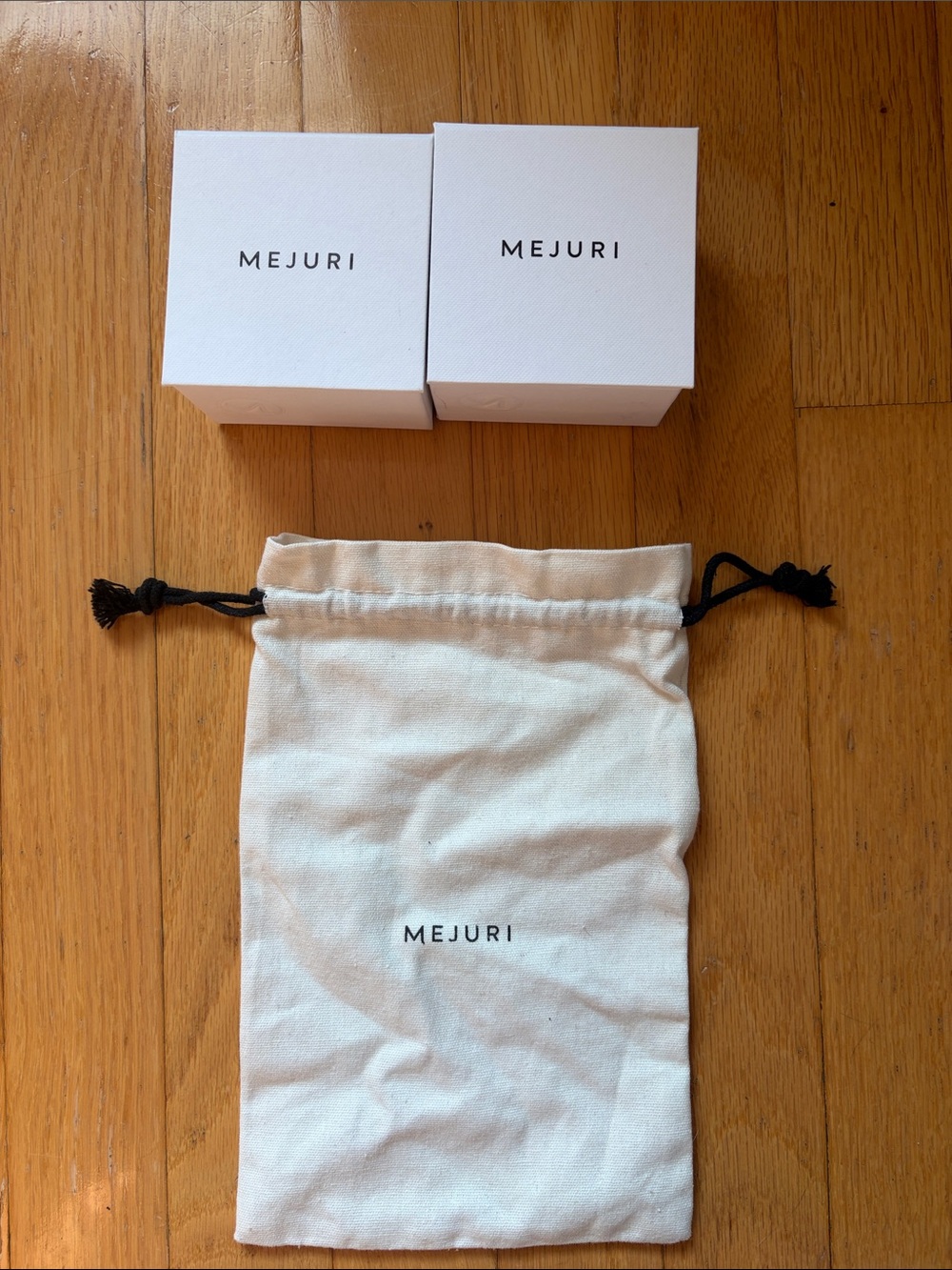 Mejuri jewelry boxes and a jewelry bag